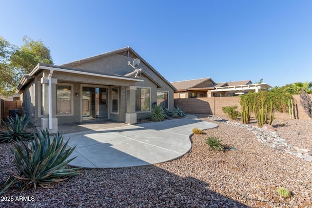 rear view of property featuring a patio area