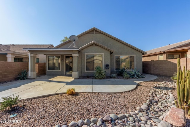 back of house with a patio