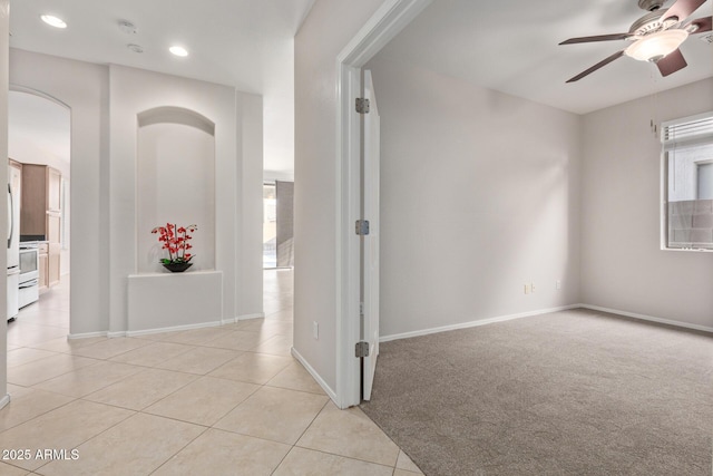 corridor with a wealth of natural light and light tile patterned floors