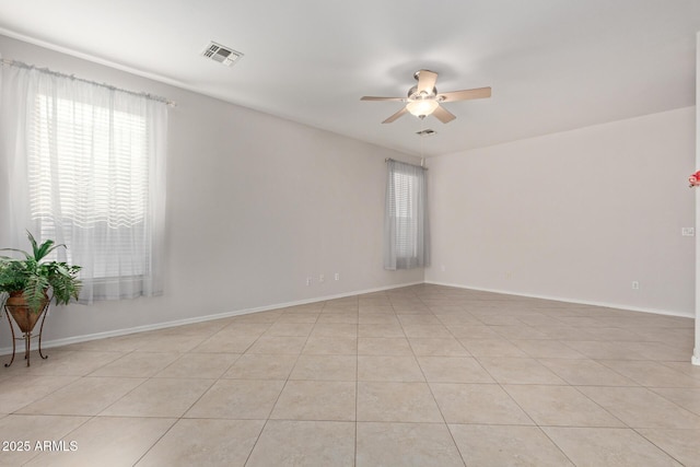 spare room with light tile patterned floors and ceiling fan