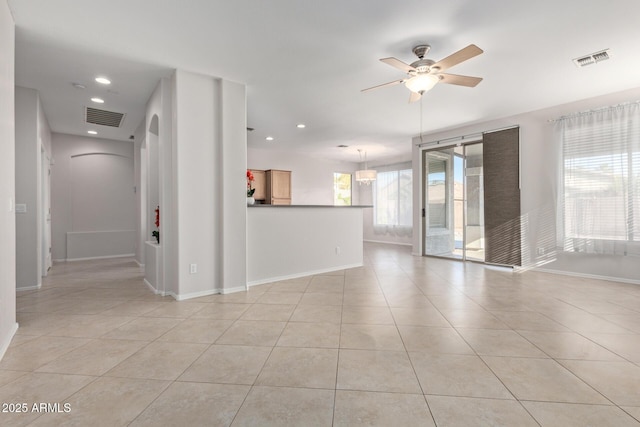 unfurnished room featuring light tile patterned flooring and ceiling fan