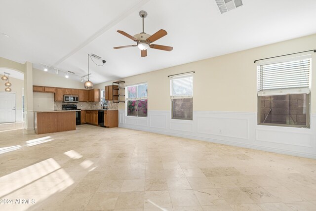 unfurnished living room featuring ceiling fan, sink, and lofted ceiling