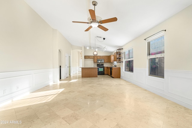 unfurnished living room with ceiling fan and lofted ceiling