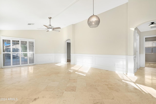 spare room featuring ceiling fan and vaulted ceiling