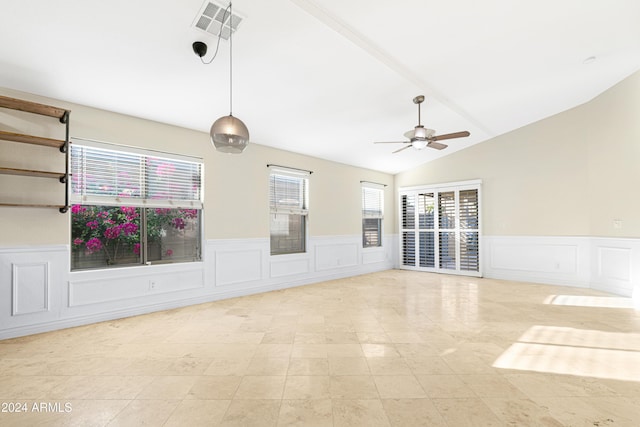 spare room featuring plenty of natural light, vaulted ceiling, and ceiling fan