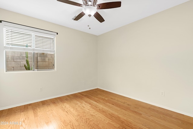 empty room with light hardwood / wood-style floors and ceiling fan