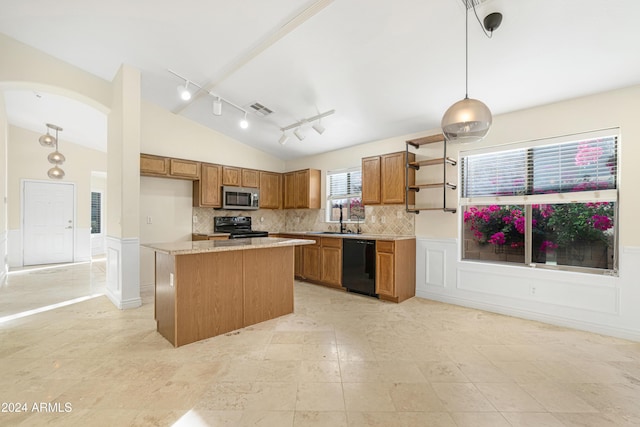 kitchen featuring vaulted ceiling, decorative light fixtures, tasteful backsplash, a kitchen island, and black appliances