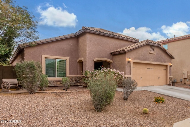 mediterranean / spanish home featuring driveway, stucco siding, and an attached garage
