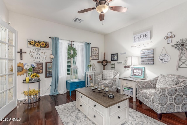 sitting room featuring wood finished floors, visible vents, and a ceiling fan