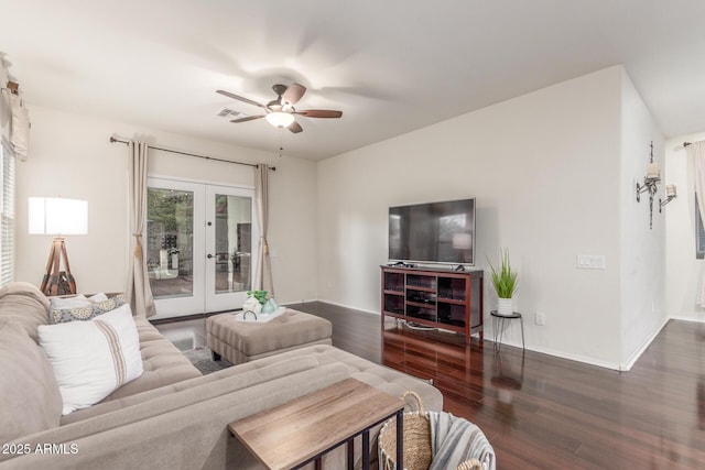 living room featuring ceiling fan, french doors, visible vents, baseboards, and wood finished floors
