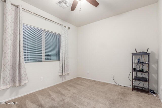 empty room featuring baseboards, visible vents, a ceiling fan, and carpet flooring