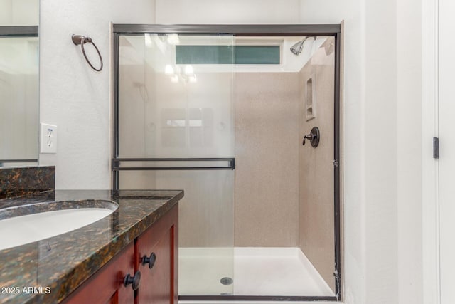 full bathroom featuring a shower stall and vanity