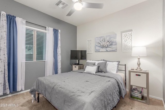 carpeted bedroom featuring visible vents and a ceiling fan