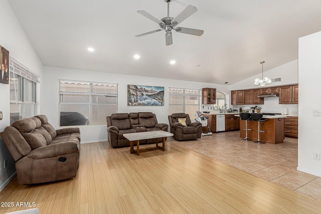 20424 N 96th Ln, Peoria, AZ 85382 - living area with a ceiling fan, high vaulted ceiling, baseboards, a chandelier, and light wood finished floors