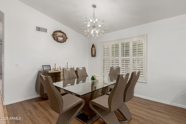 20424 N 96th Ln, Peoria, AZ 85382 - dining space featuring a chandelier, wood finished floors, and baseboards