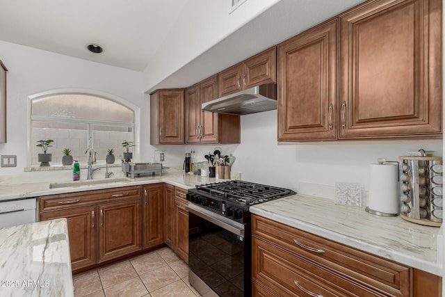 20424 N 96th Ln, Peoria, AZ 85382 - kitchen with range with gas cooktop, under cabinet range hood, a sink, brown cabinetry, and light tile patterned flooring