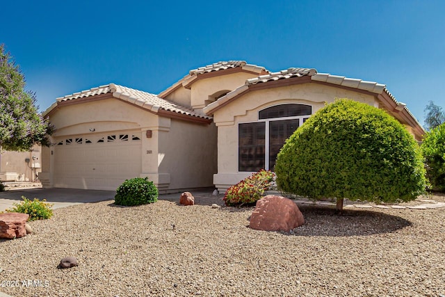 20424 N 96th Ln, Peoria, AZ 85382 - mediterranean / spanish home with an attached garage, a tile roof, stucco siding, and driveway
