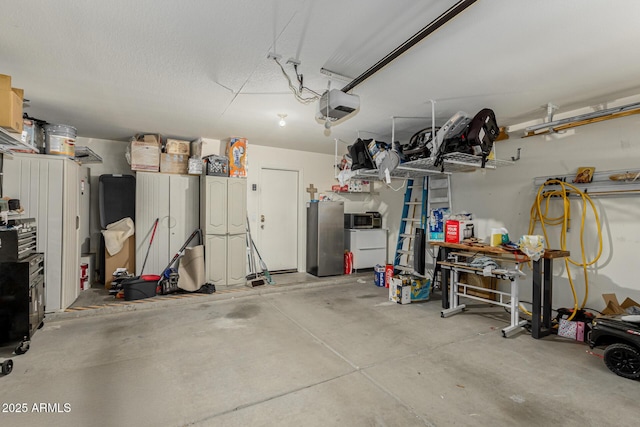 20424 N 96th Ln, Peoria, AZ 85382 - garage featuring freestanding refrigerator and a garage door opener