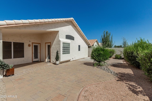 20424 N 96th Ln, Peoria, AZ 85382 - back of house featuring stucco siding, a patio, a fenced backyard, and a tile roof