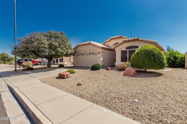 20424 N 96th Ln, Peoria, AZ 85382 - mediterranean / spanish-style house featuring stucco siding, concrete driveway, a garage, and a tile roof