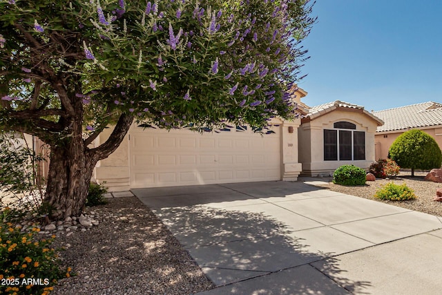 20424 N 96th Ln, Peoria, AZ 85382 - view of front of property featuring driveway, stucco siding, a tile roof, and an attached garage