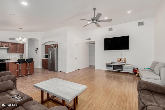 20424 N 96th Ln, Peoria, AZ 85382 - living room with arched walkways, a ceiling fan, recessed lighting, and light wood-style floors