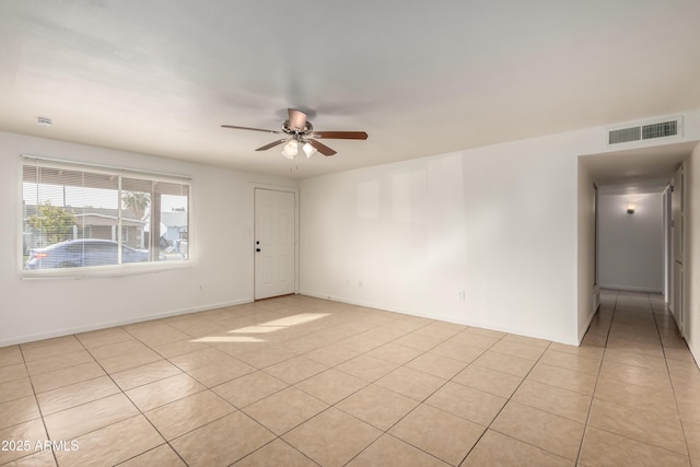 empty room with ceiling fan and light tile patterned flooring