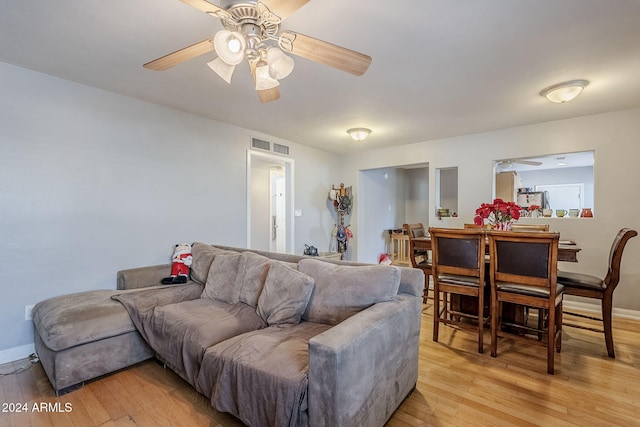 living room featuring light hardwood / wood-style floors and ceiling fan