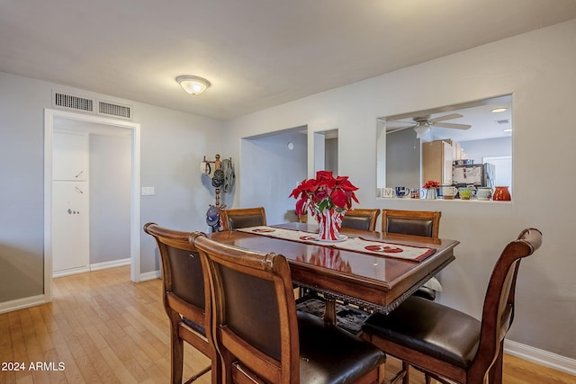 dining space with ceiling fan and light hardwood / wood-style flooring