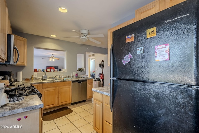 kitchen with appliances with stainless steel finishes, light brown cabinetry, ceiling fan, sink, and light tile patterned floors