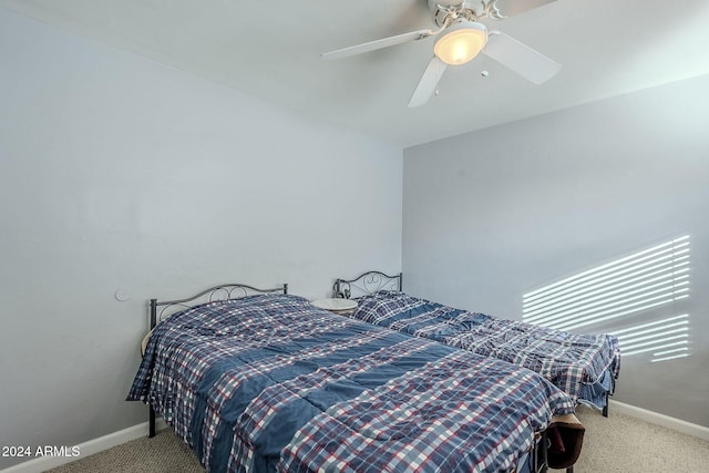 bedroom with ceiling fan and light carpet