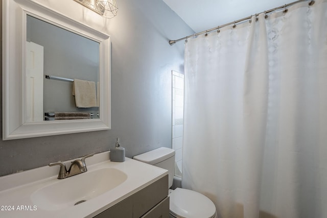 full bathroom with shower / tub combo, vanity, and toilet