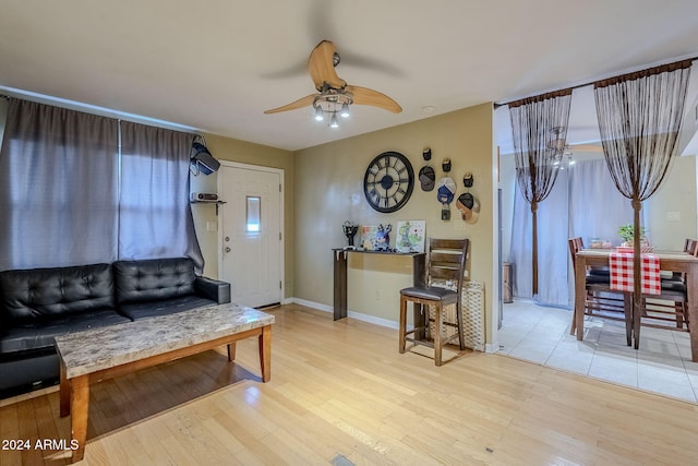 living room featuring ceiling fan and light wood-type flooring