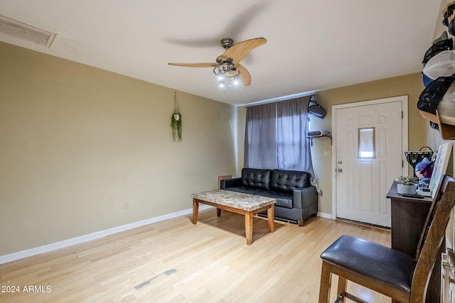 living room featuring light hardwood / wood-style floors and ceiling fan