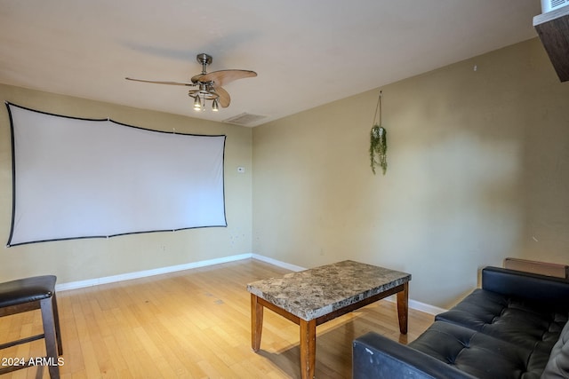 home theater featuring ceiling fan and light wood-type flooring