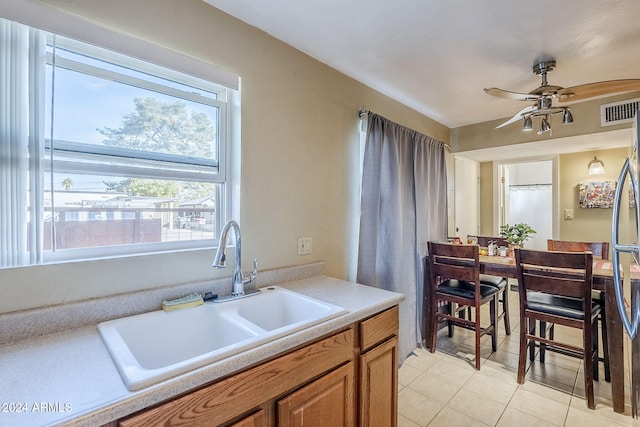 kitchen with ceiling fan, light tile patterned floors, and sink