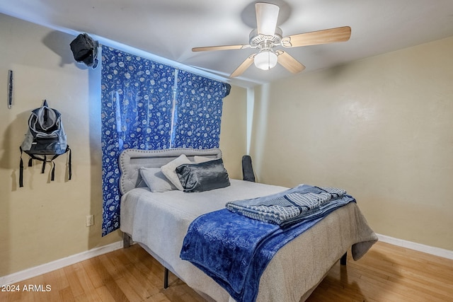 bedroom featuring ceiling fan and hardwood / wood-style flooring