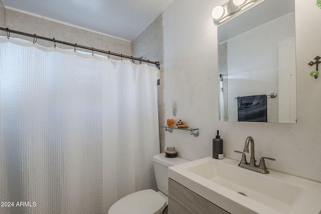 bathroom with vanity, toilet, and curtained shower