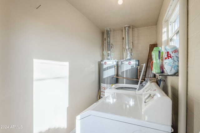 laundry area with washing machine and clothes dryer and water heater