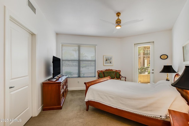 carpeted bedroom with baseboards and a ceiling fan