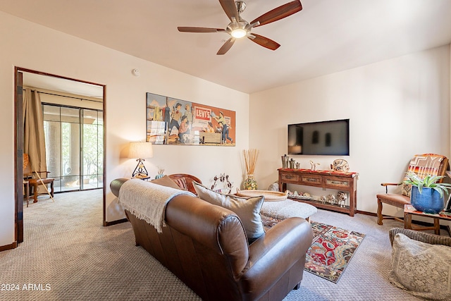 carpeted living room with baseboards and ceiling fan