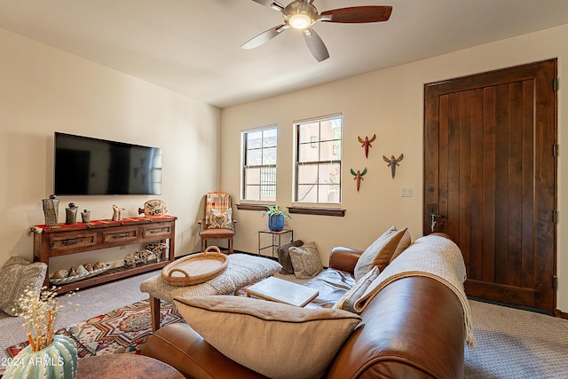 carpeted living area featuring a ceiling fan