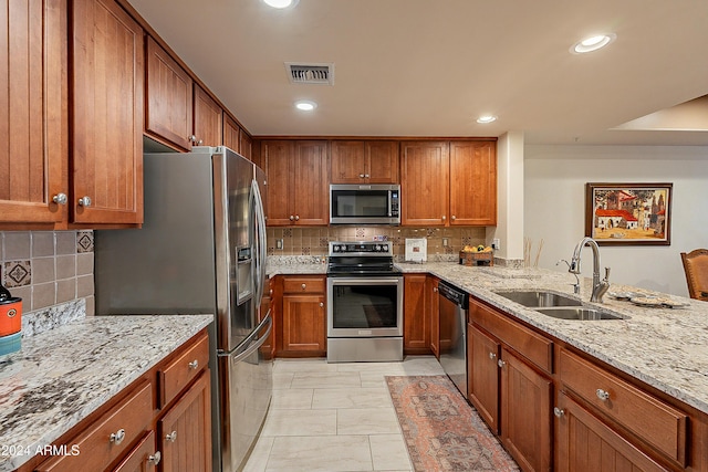 kitchen with visible vents, brown cabinets, appliances with stainless steel finishes, and a sink