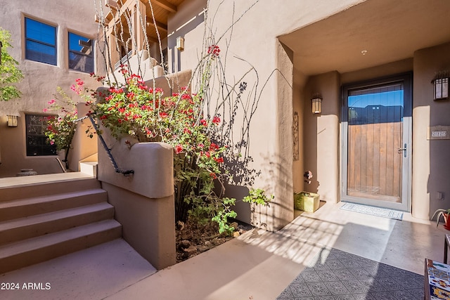 entrance to property featuring stucco siding