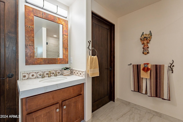 bathroom featuring marble finish floor and vanity