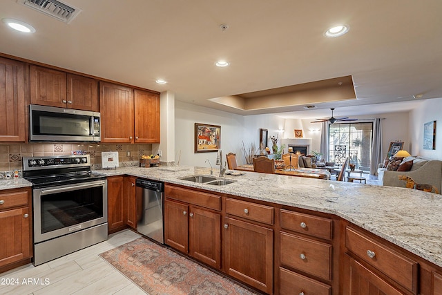 kitchen with a sink, visible vents, appliances with stainless steel finishes, and open floor plan