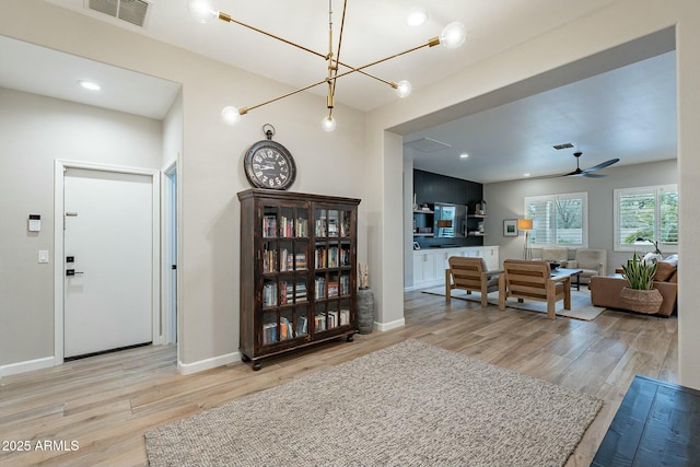 living room featuring light hardwood / wood-style flooring and ceiling fan