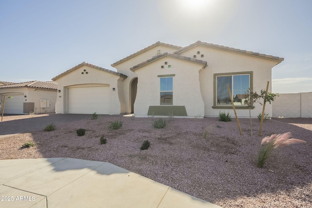 mediterranean / spanish-style home featuring cooling unit and a garage