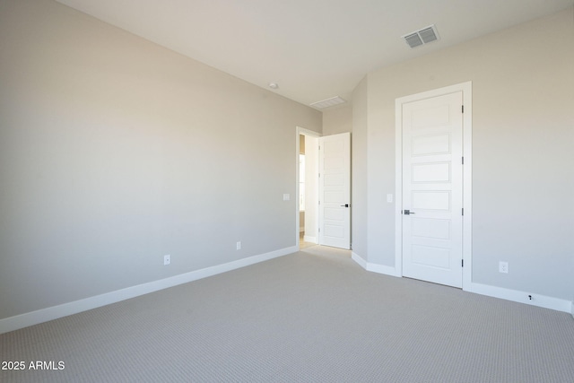 unfurnished bedroom featuring light carpet and a closet