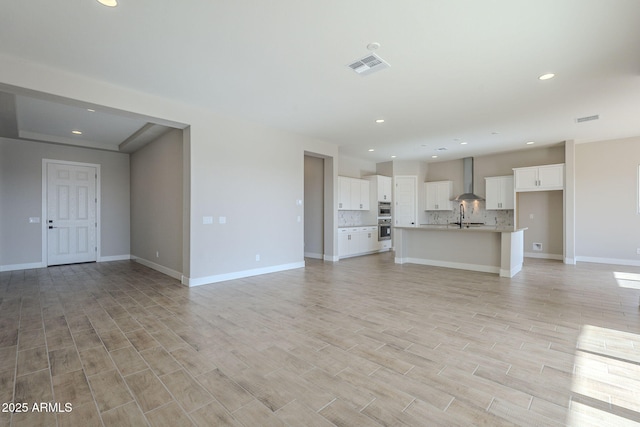 unfurnished living room with sink